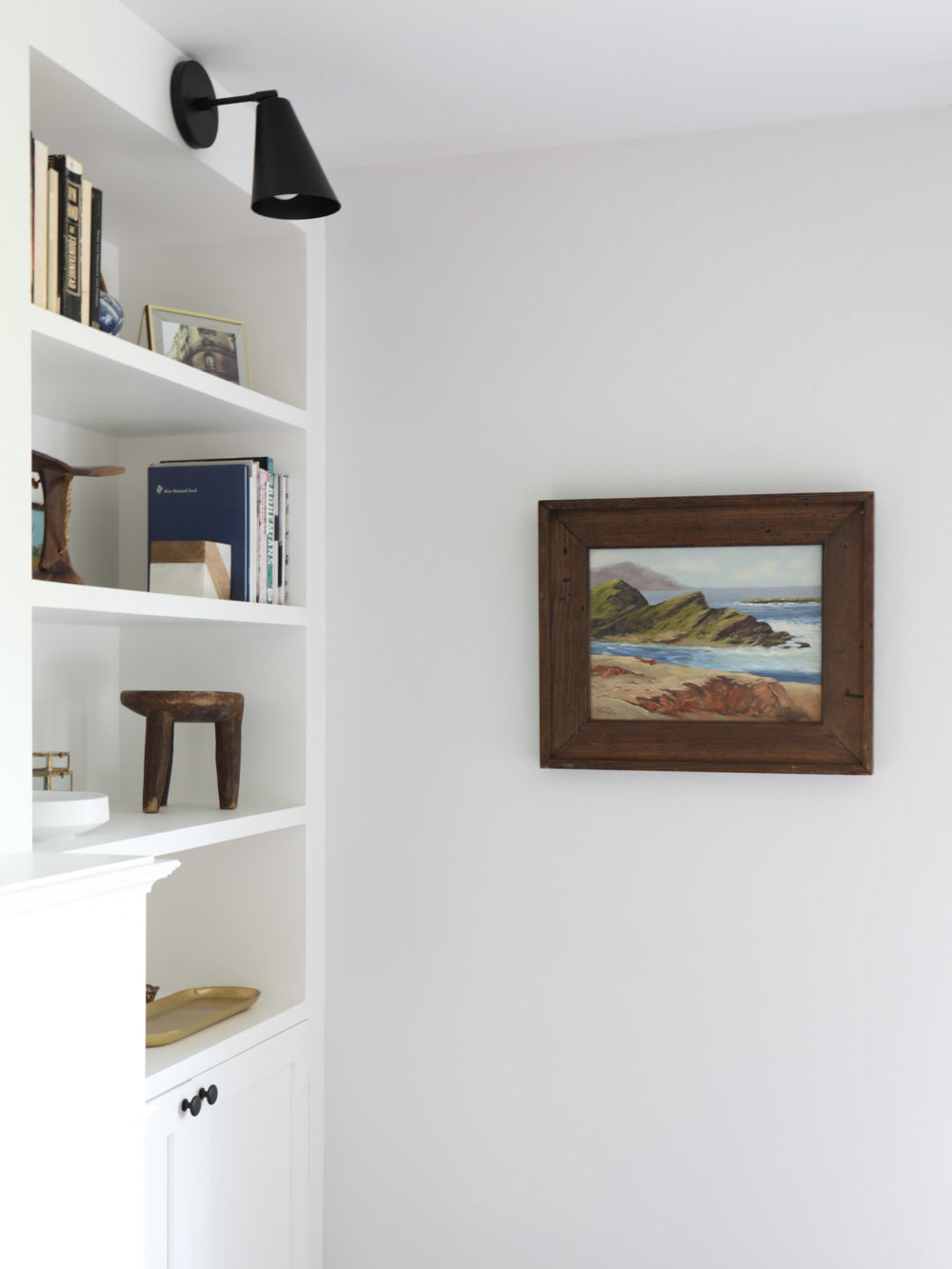 vintage seascape and built in bookshelves