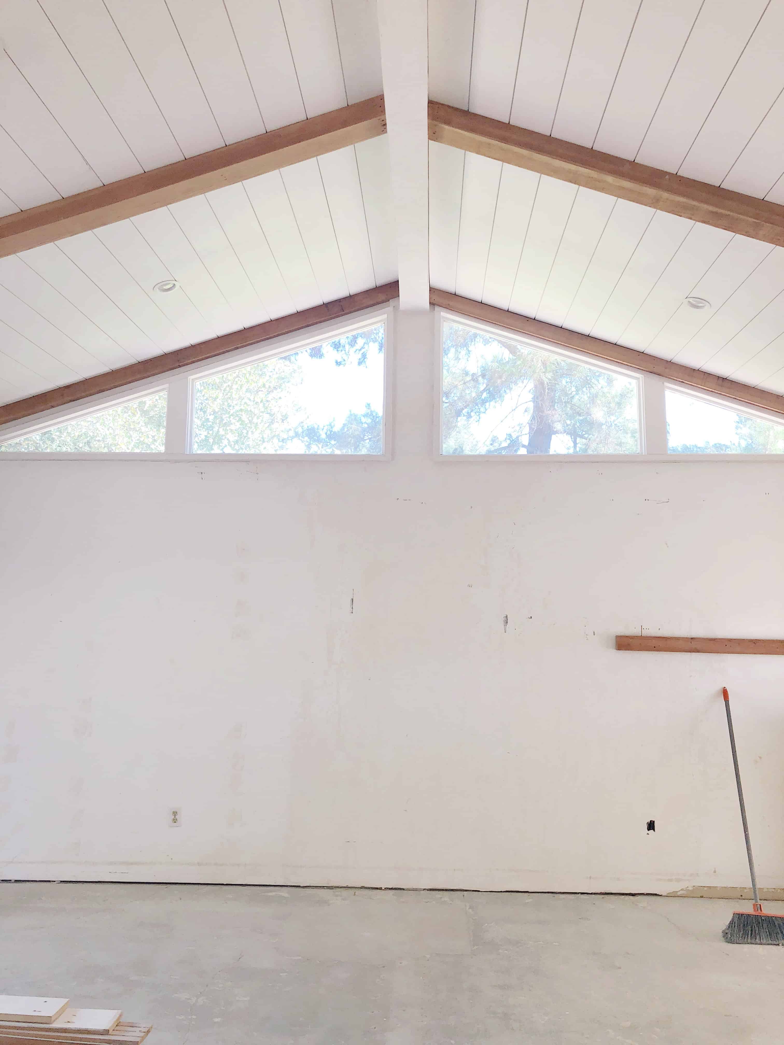 Shiplap paneled ceiling with wood beams