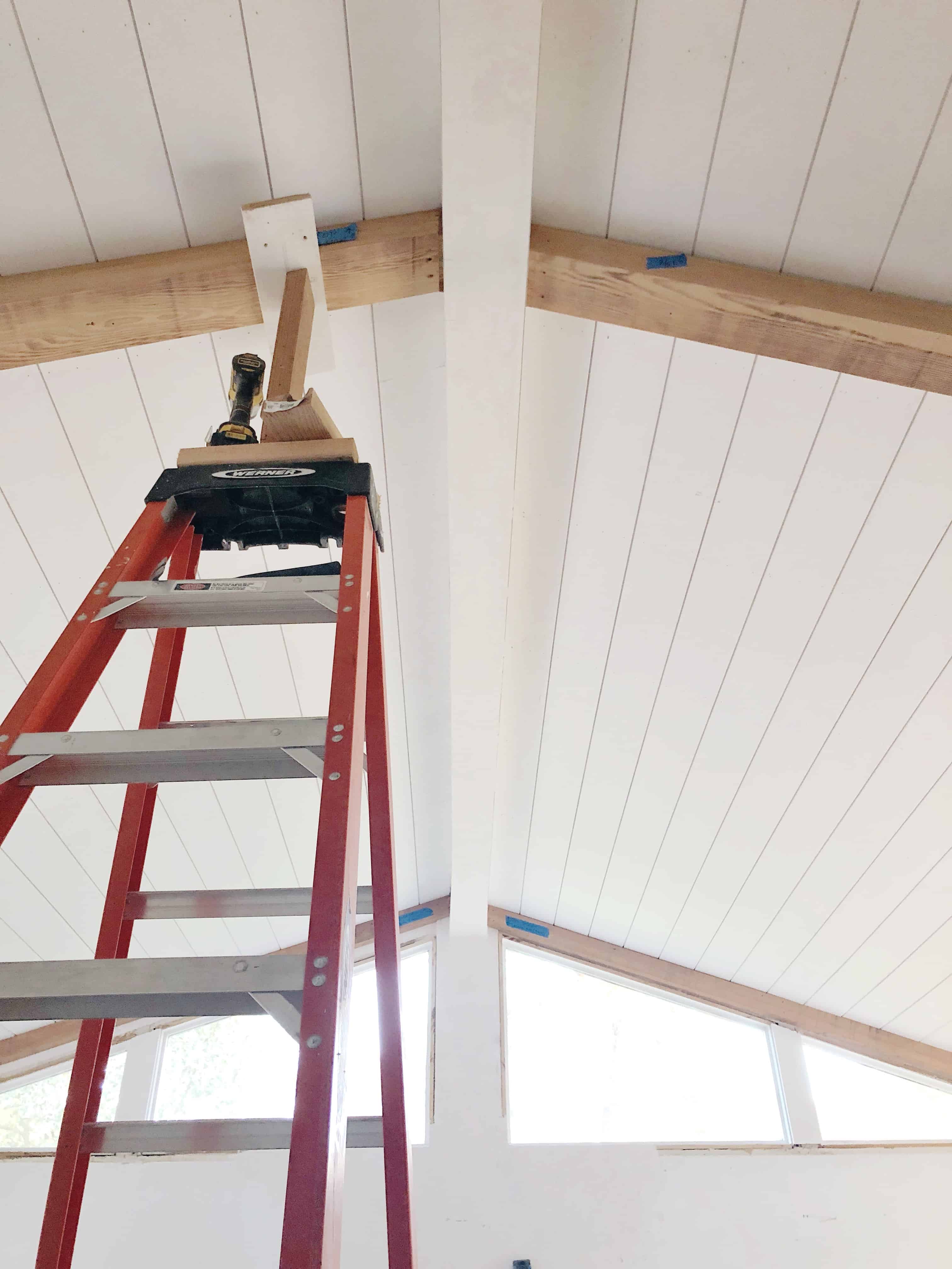 Shiplap paneled ceiling with wood beams